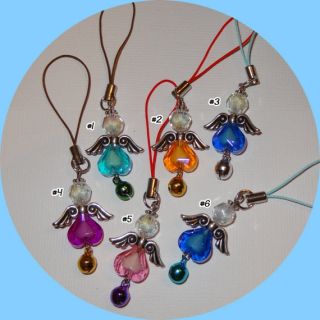   beads, metal wings, and a bell; and attached to a cell phone strap