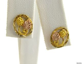   gold and acorn in yellow gold. Each earring has a stick post with a