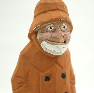 This 6.75 hand carved wooden figurine features an Old Salt/ Fisherman