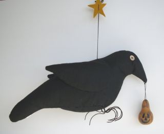 Wonderful large primitive crow with dangling pumpkin and star!