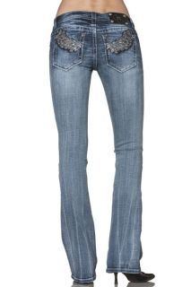 Medium wash boot cut jean with heavy fading and whiskering throughout
