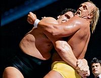 Andre the Giant applying a bear hug to Hulk Hogan in their WWF