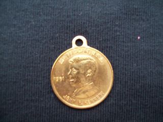 John F Kennedy commerative gold colored coin 1961