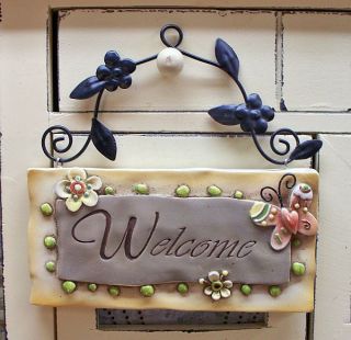 garden sign this item is a resin sign with a metal flower and leaf