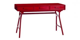 Described as a standard desk, this red lacquered version is anything