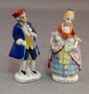 This pair of ceramic figurines stands about 3 tall. They are both in
