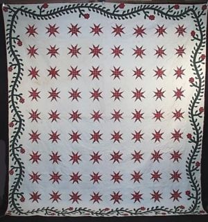 1850S QUILTED APPLIQUED STAR QUILT WITH FLORAL VINE TRAILING BORDER