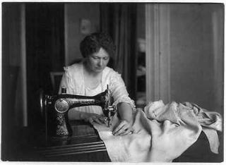 Woman sewing with a Singer sewing machine,c1917,Womens war work,World